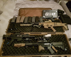 A bundle of guns and clothing - Used airsoft equipment